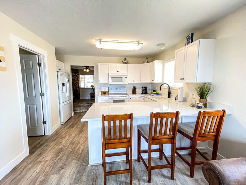 Updated clean and sleek kitchen perfect for cooking and dining together.
