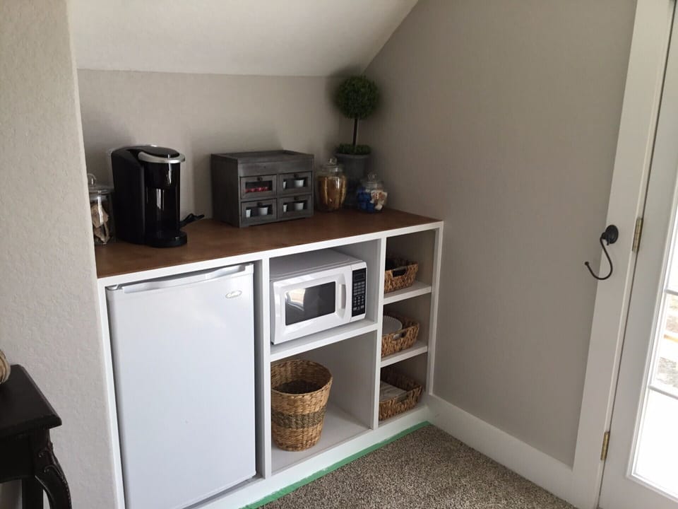 Fully stocked coffee/tea bar with small refrigerator and microwave