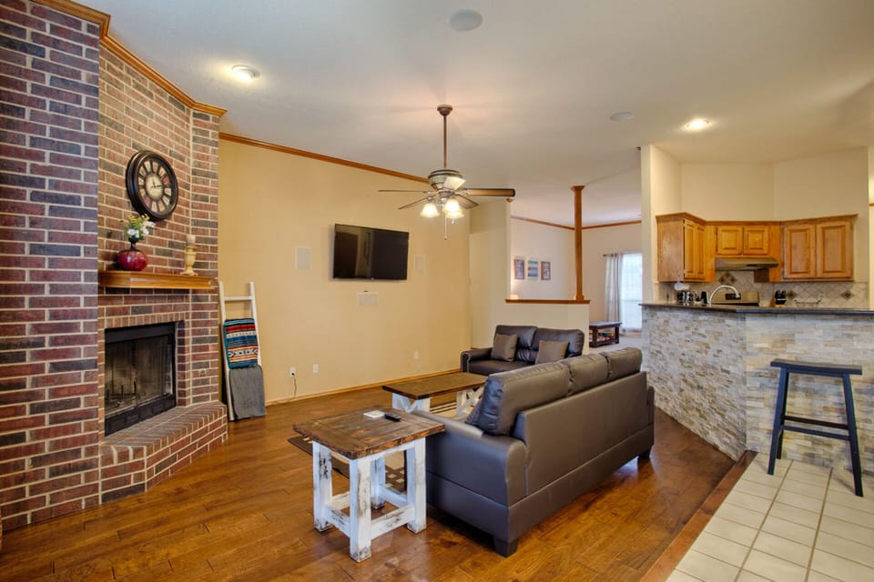 Living room with couch, love seat, 55 inch TV and gas fireplace