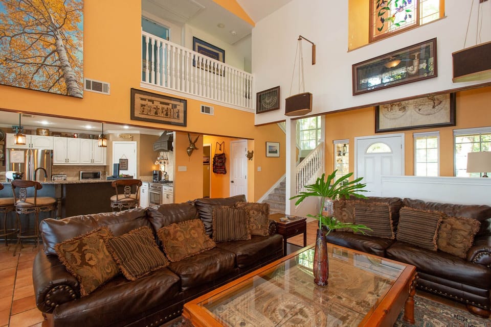 First living area with comfortable seating open to kitchen and dining spaces. 