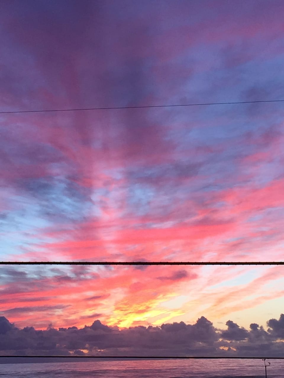 Sunset over the ocean from house window