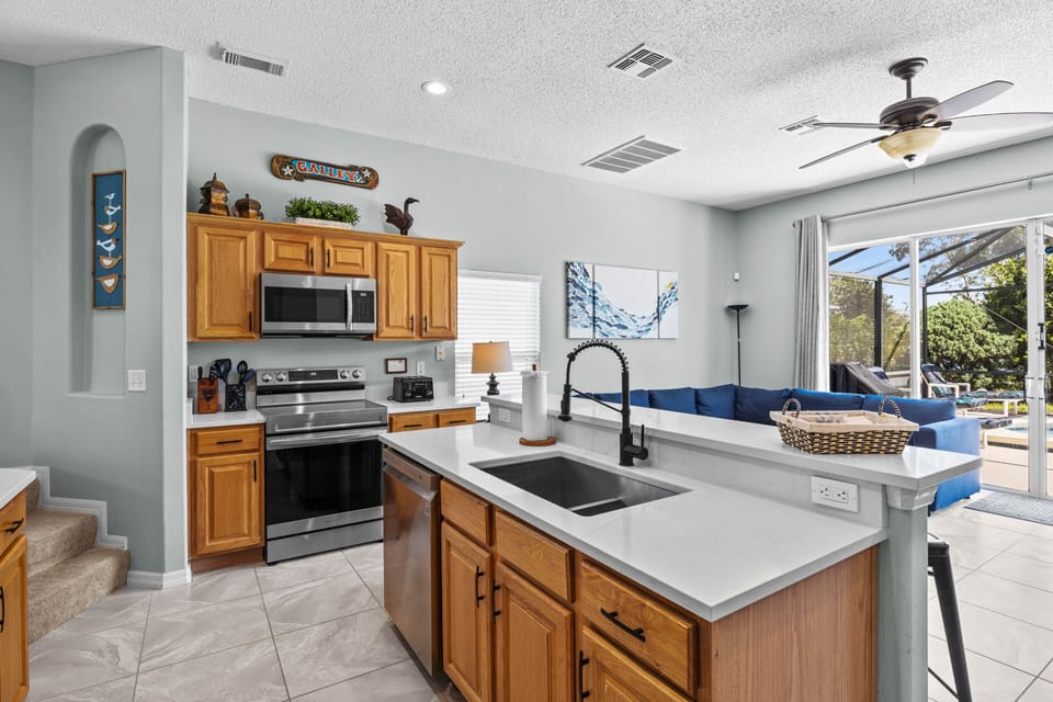 Fully stocked kitchen with quartz countertops and stainless steel applicances