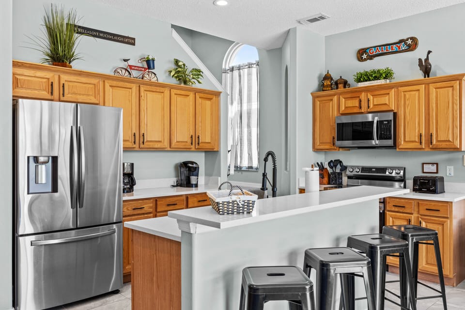 Fully stocked kitchen with quartz countertops and stainless steel applicances
