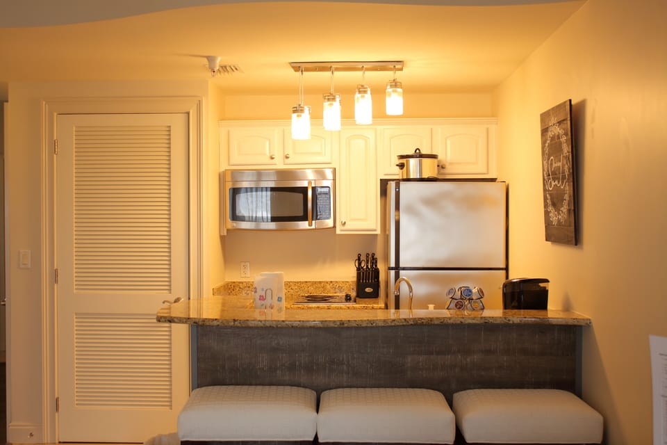 kitchen with stove, microwave, and keurig
