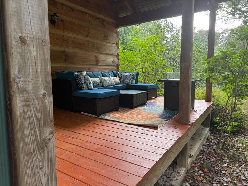 The new covered porch with fire pit, grill and seating. 