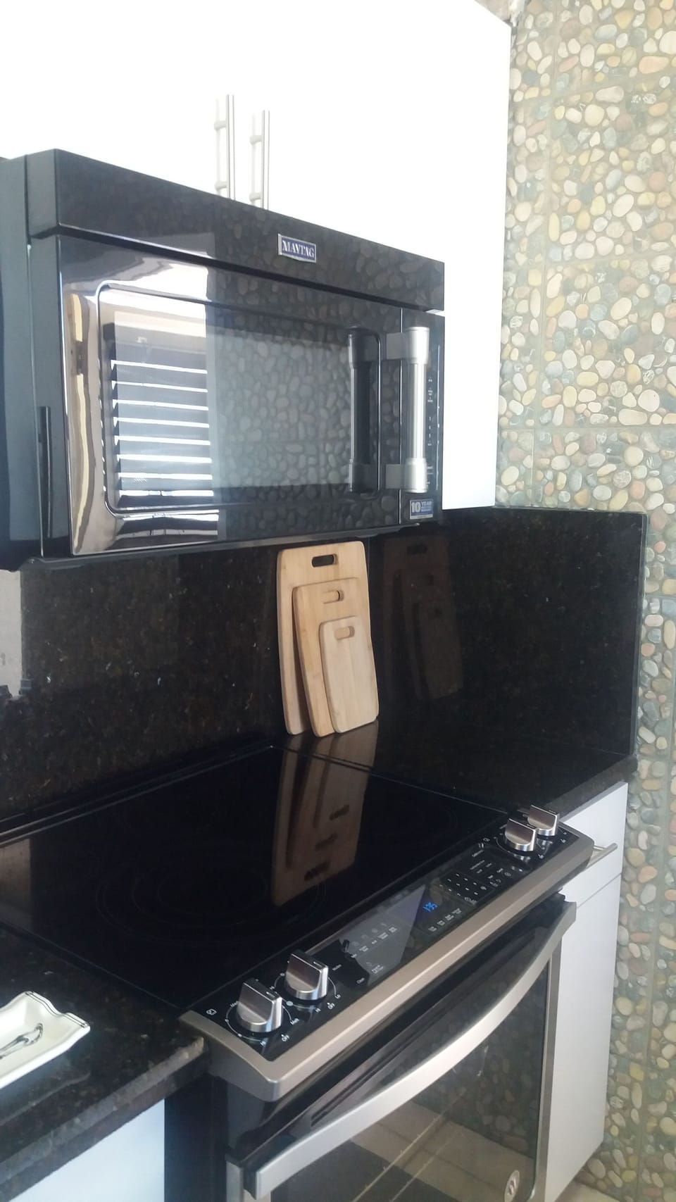 Granite counter tops and full size, stainless appliances. 