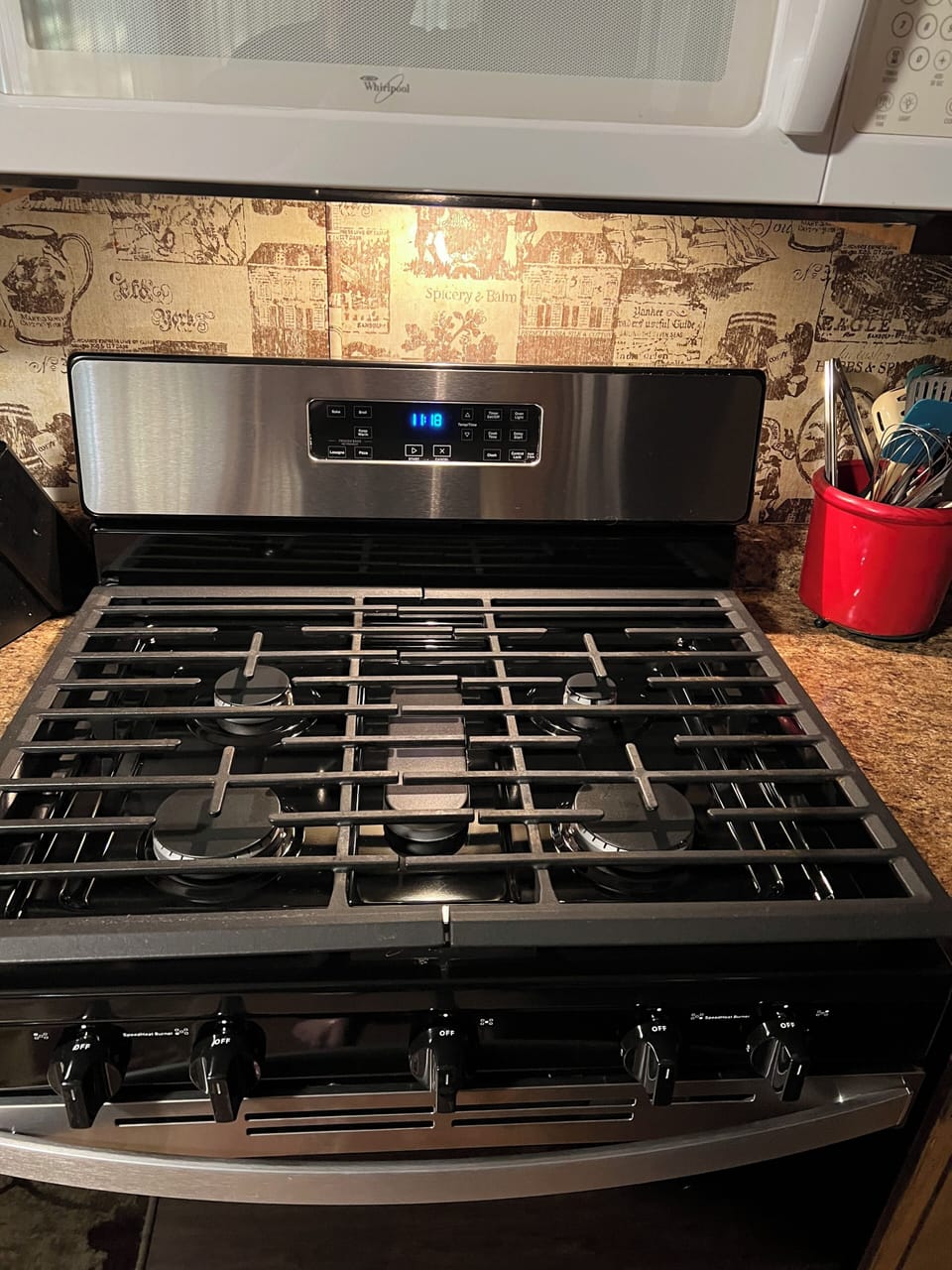Four-burner propane gas cooktop and oven included.