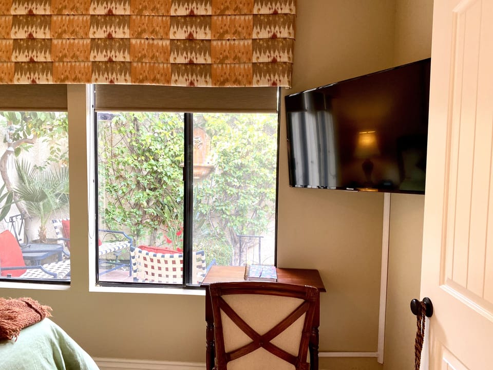 Large screen TV and a desk with a view.
This master has double doors and dresser