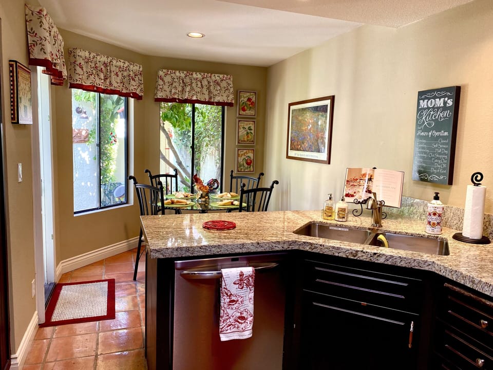 Light and bright kitchen, fully stocked with a door to the front patio.