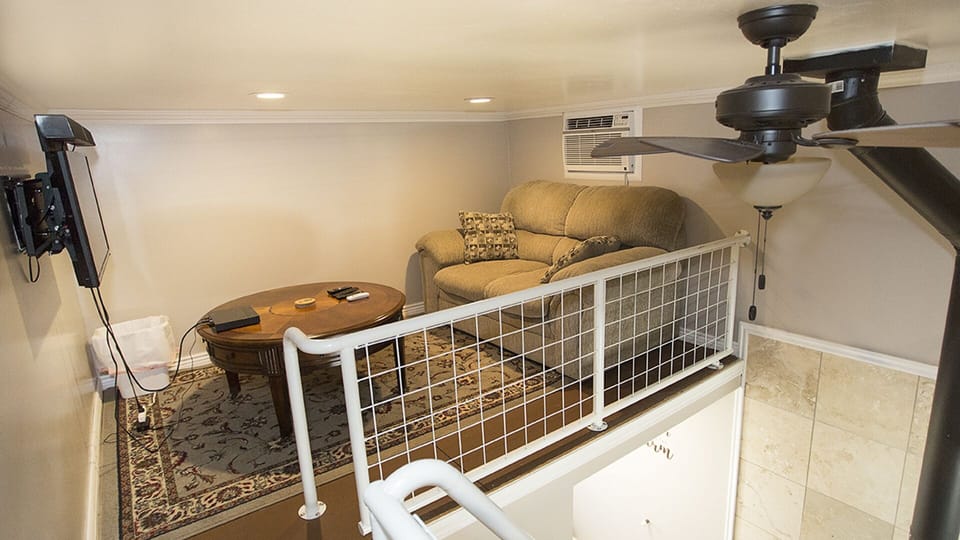 Enjoy the remote controlled AC unit while watching your favorite movie on the cozy couch.