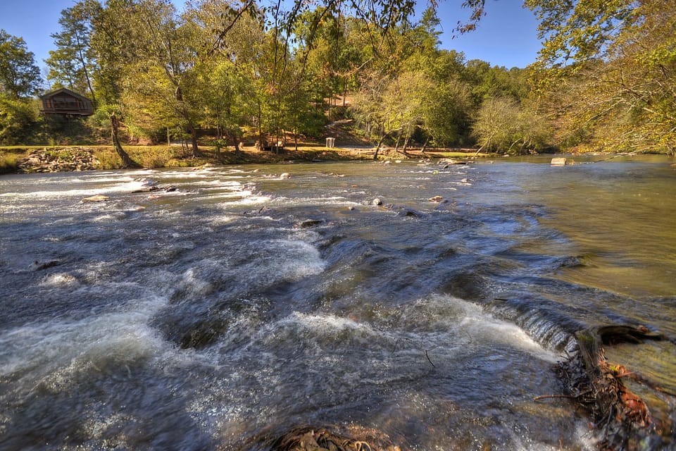 Along resort's tube run, shallow enough to wade or sit in camping chairs
