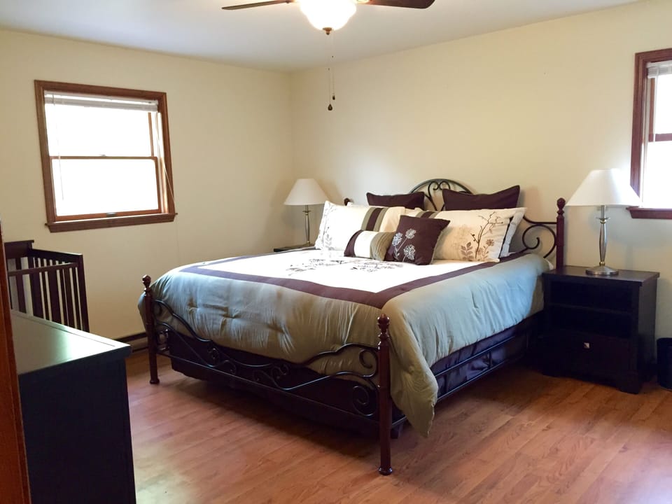 Master bed with master bath, king bed, and a crib 