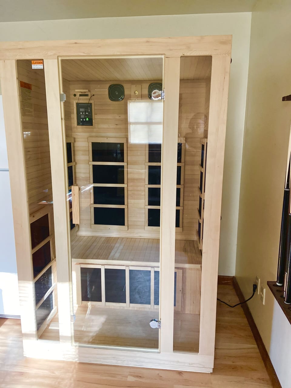Sauna and spare refrigerator in the game room. 