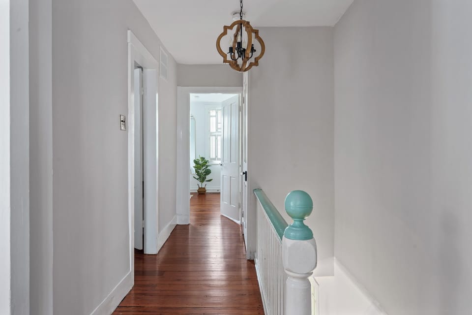 Upstairs hallway leading to bedrooms and additional bathrooms