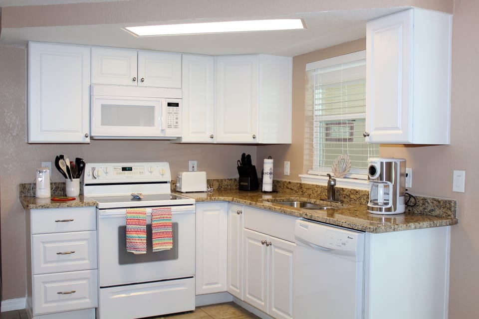 White kitchen with new cabinets and granite
