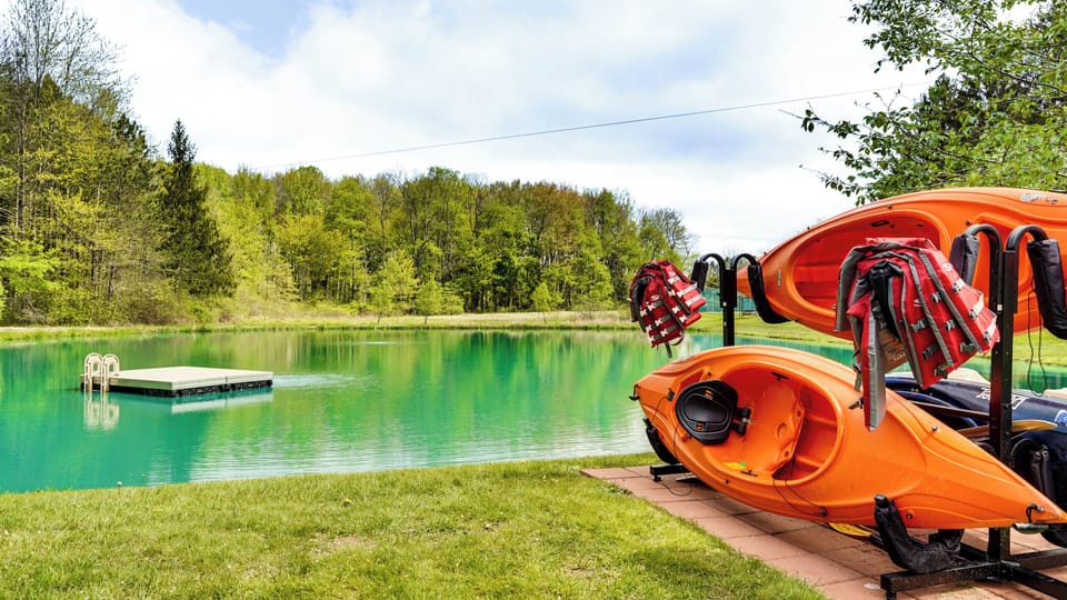 Clear, spring-fed pond with kayaks and a floating dock, ideal for swimming, paddling, fishing, or relaxing by the water. Enjoy peaceful pond views, nature sounds, and a private outdoor escape perfect for unwinding and reconnecting outdoors.