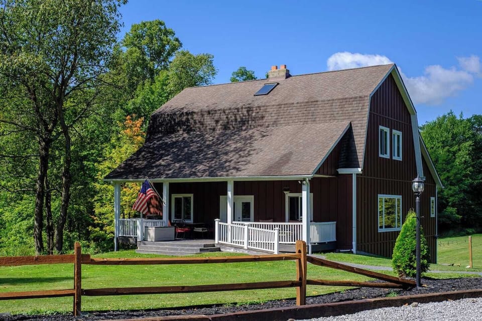 Recently restored 3,500 sq ft, 3-level home blending rustic charm with modern comfort. Set on a scenic hillside with acres of trees, trails, pond, sports court, large front porch, backyard dining, and a ramped front entry for easy access and luggage.