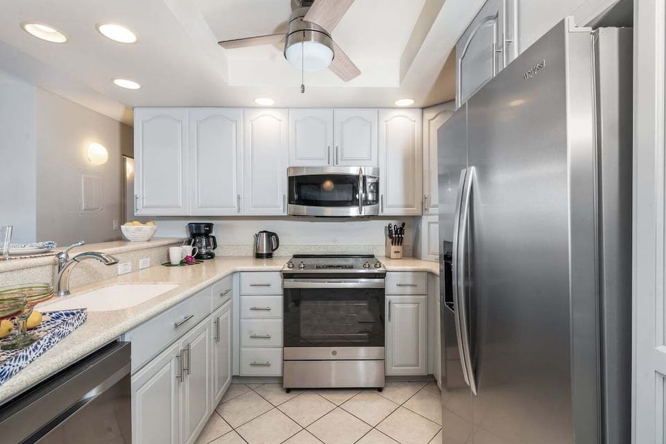 Modern and stainless steel appliance and white cabinetry featured in your kitchen