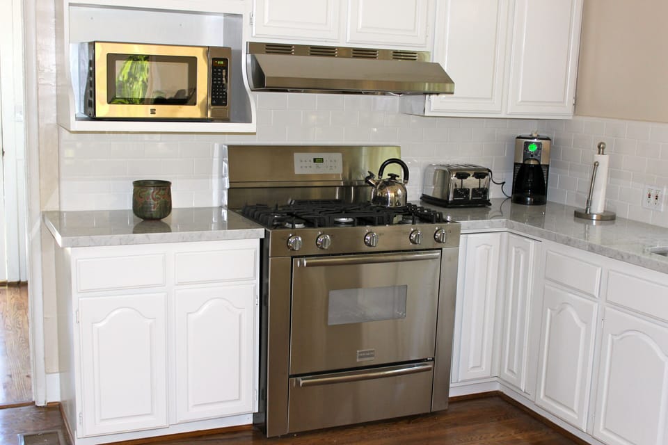 Kitchen with stainless steel appliances and marble countertops.