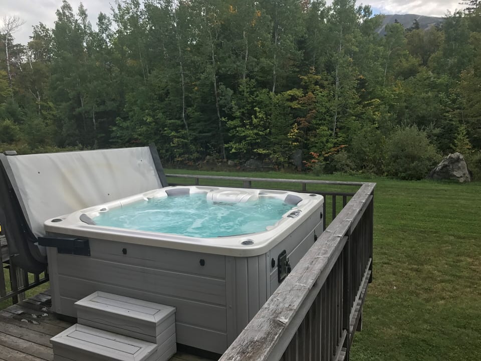 6 person with water feature and multi color lights with views of the mountain.