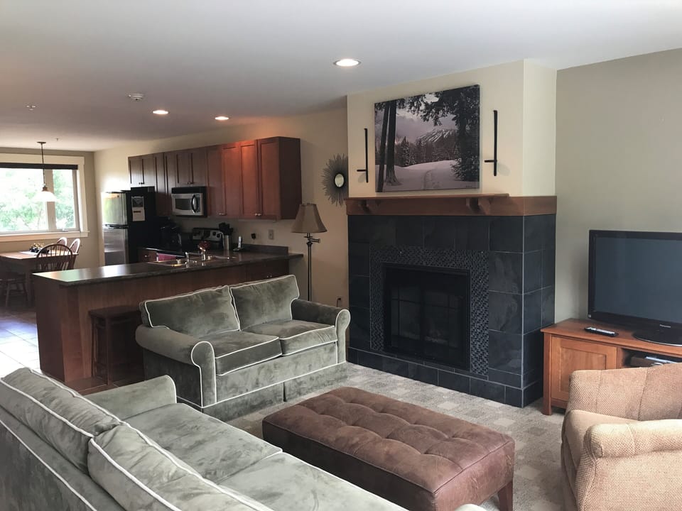 open concept living room with gas fireplace and cable TV
