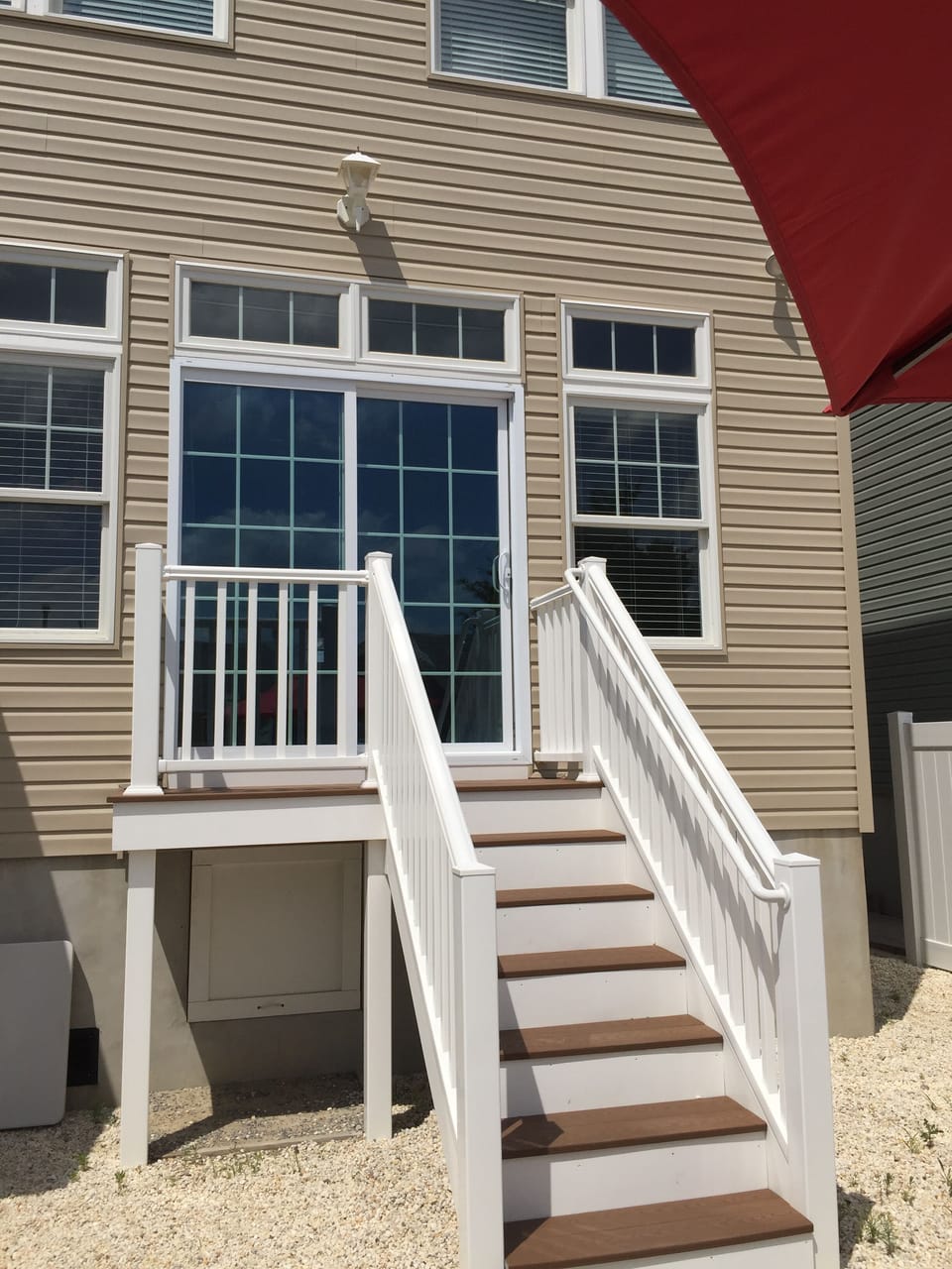 Back yard equipped with grill and outside showers 