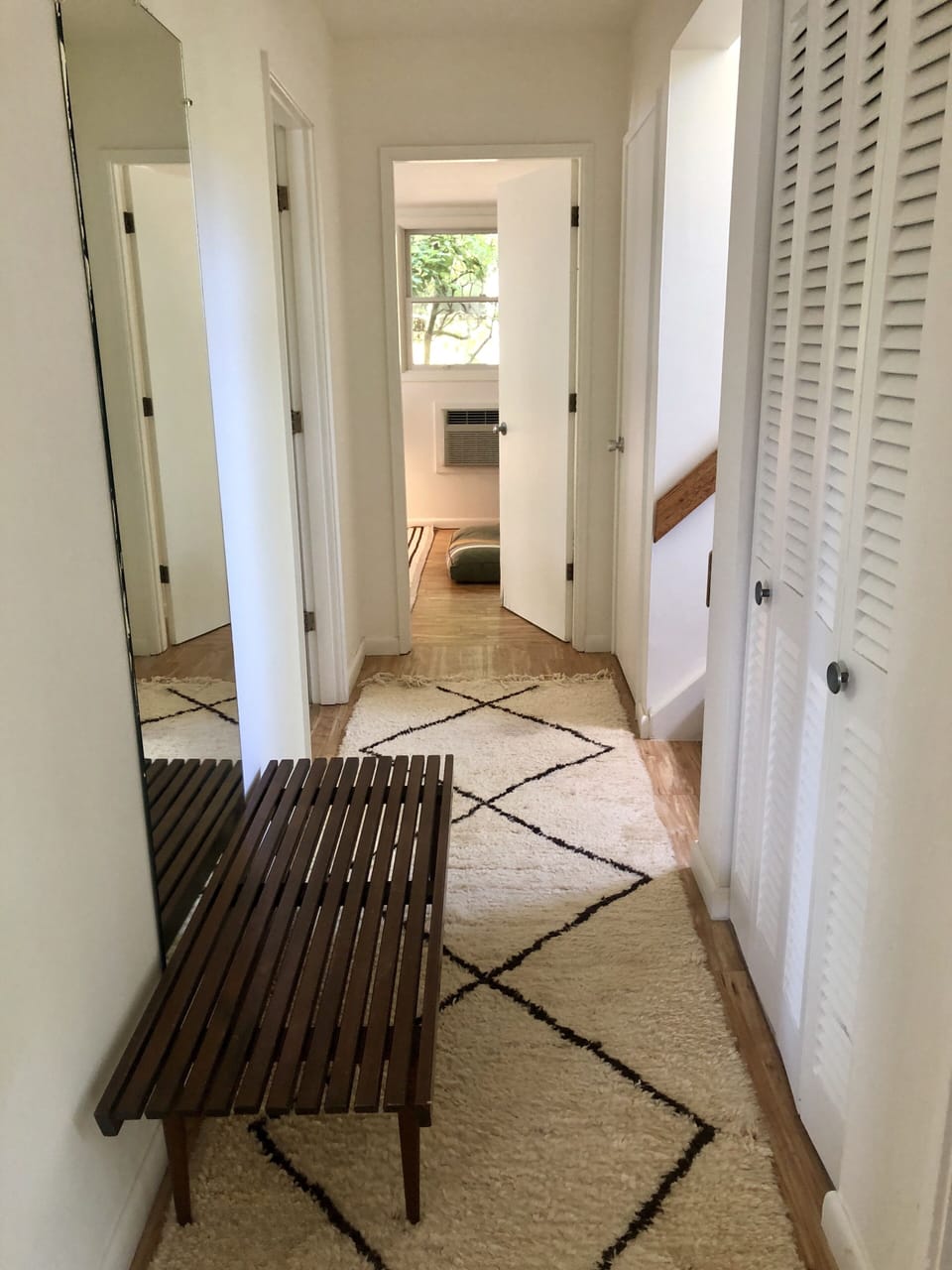 Hallway leading to all bedrooms bathrooms and outside shower and water 