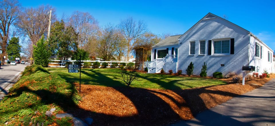 Street view showing driveway on the right side of  house.