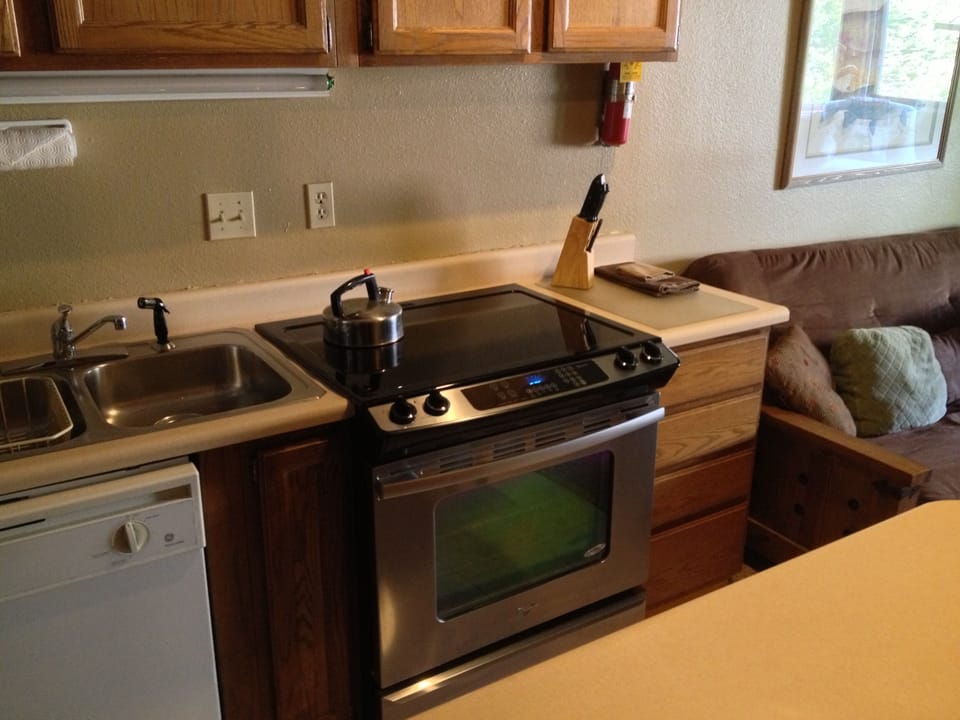 Brand new full size range with flat top stove and stainless steel oven.