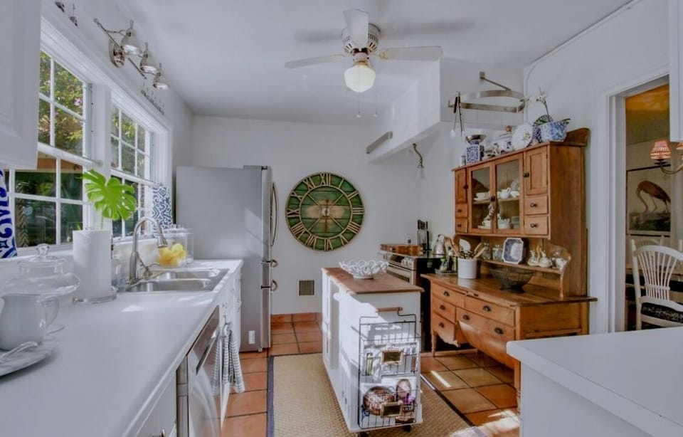 Kitchen with stainless steel appliances & antique baker's hutch