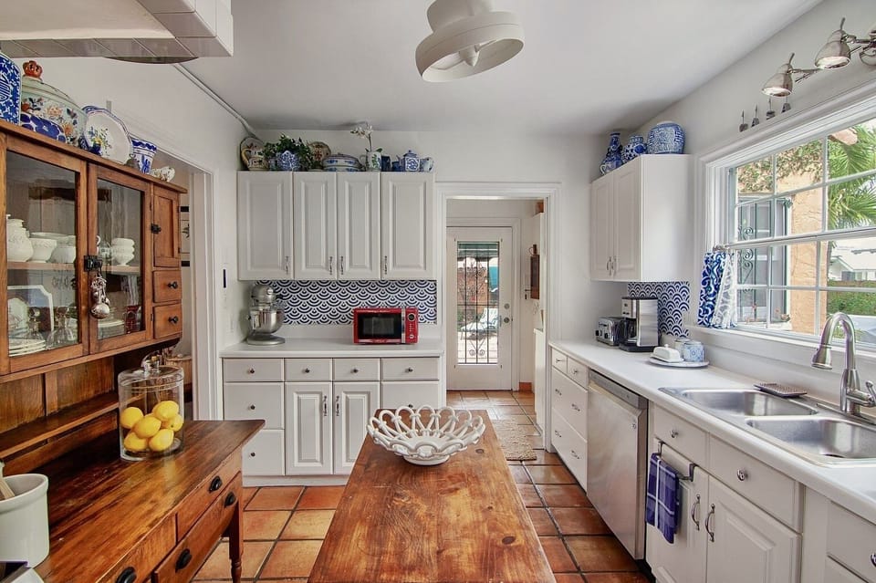 Kitchen-View of the back door, powder room is to the right. Laundry room on left