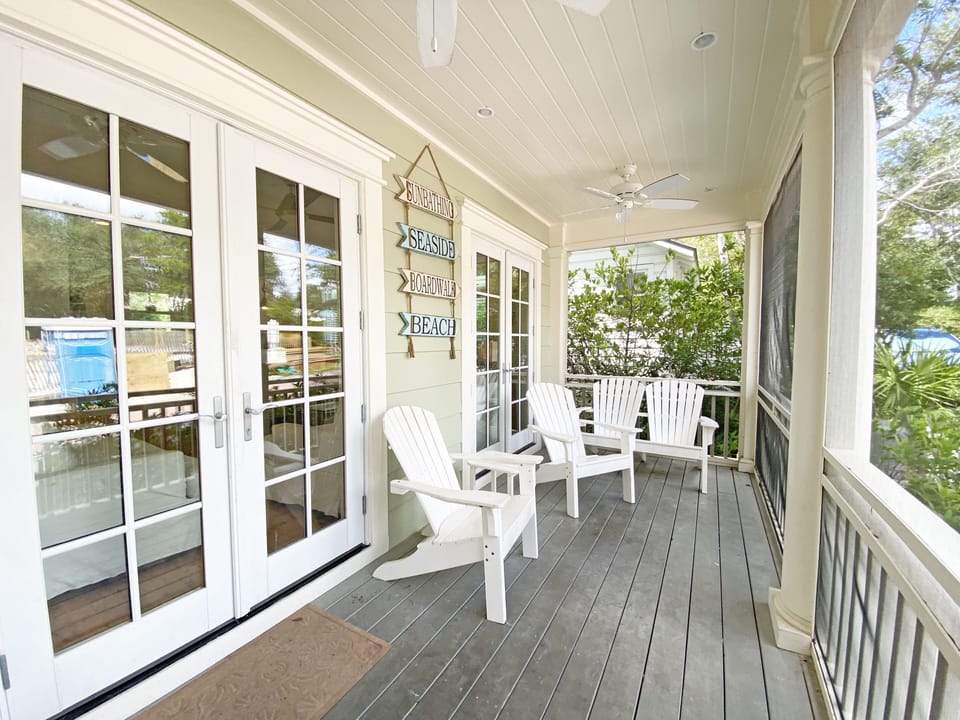 INVITING FRONT PORCH WITH ADIRONDACK SEATING
