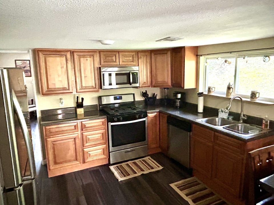 wood cabinet kitchen with new appliances, gas stove, microvawe