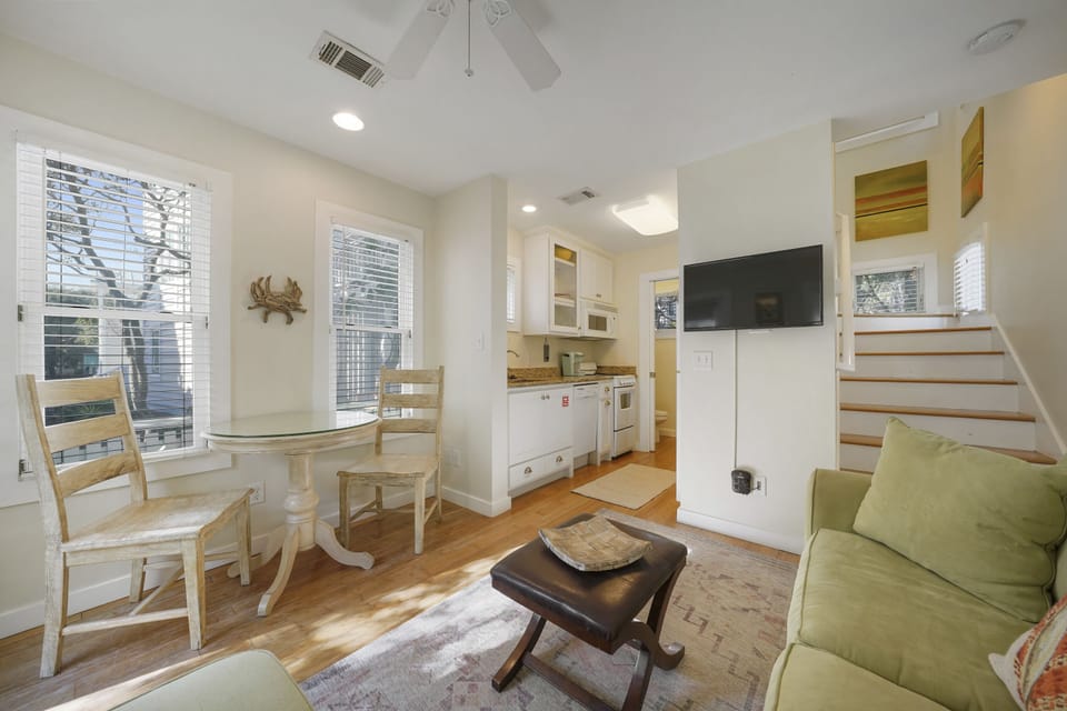 LIVING WITH FLATSCREEN NEXT TO DINING FOR TWO