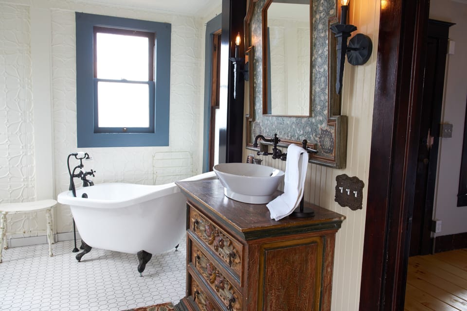 Lower level bathroom view of clawfoot tub.