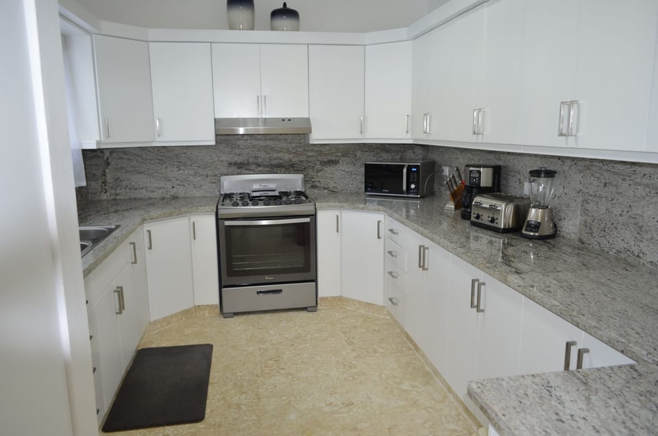 Stainless steel appliances in fully equipped kitchen Perfect for gourmet cookin