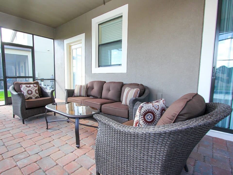 Comfortable outdoor seating under the Lanai and a table for 8 (not shown)