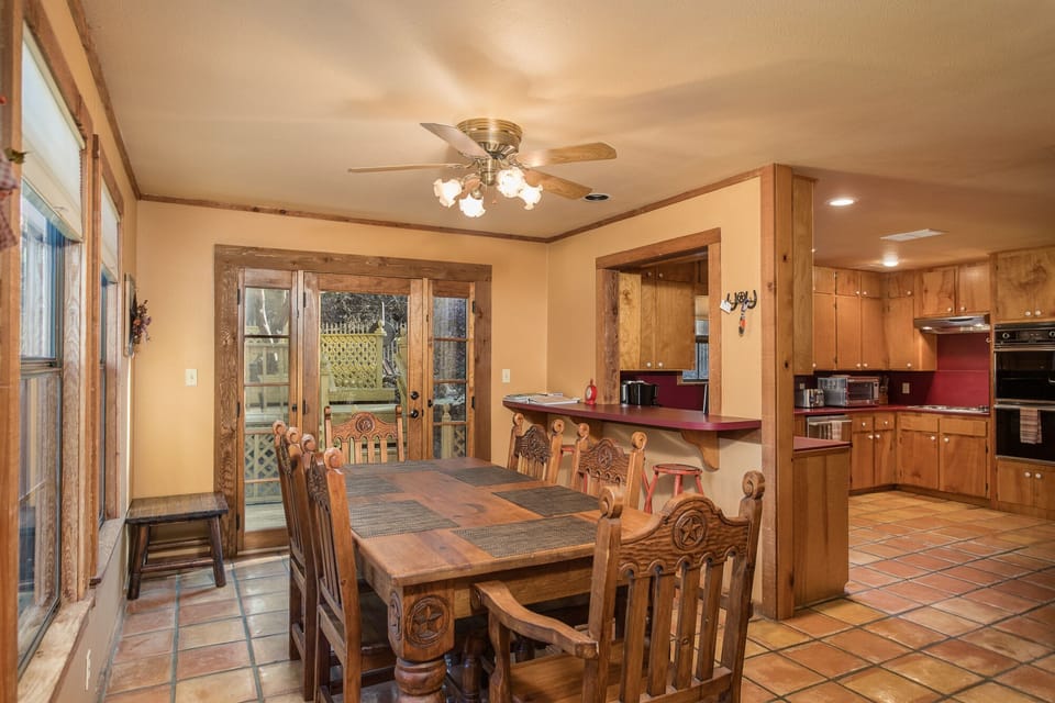 Large dining table with extra seating at the bar.