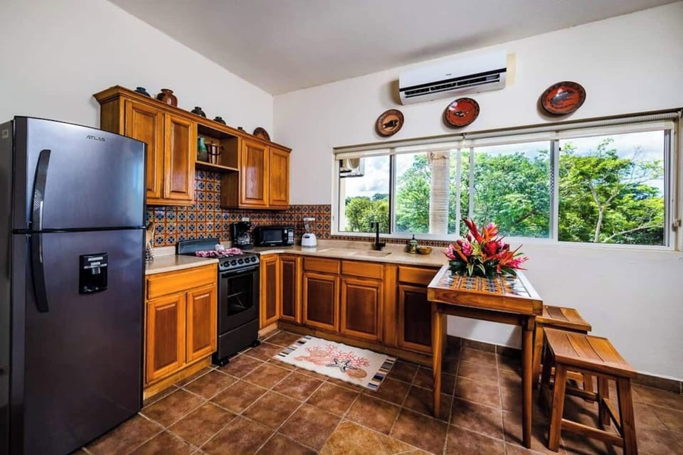Warm and colorful kitchen that makes you feel cozy at this downtown Tamarindo escape. Wood countertops, vibrant tiles, and fully equipped for cooking. Whip up fresh Costa Rican dishes or morning coffee before heading to the plunge pool.