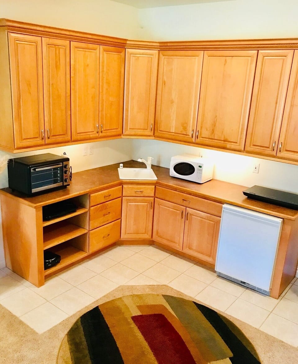 Full kitchen with stovetop, toaster oven, microwave, dishwasher, refrigerator. 