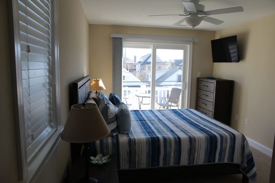 Master bedroom with queen bed, master bathroom and private balcony