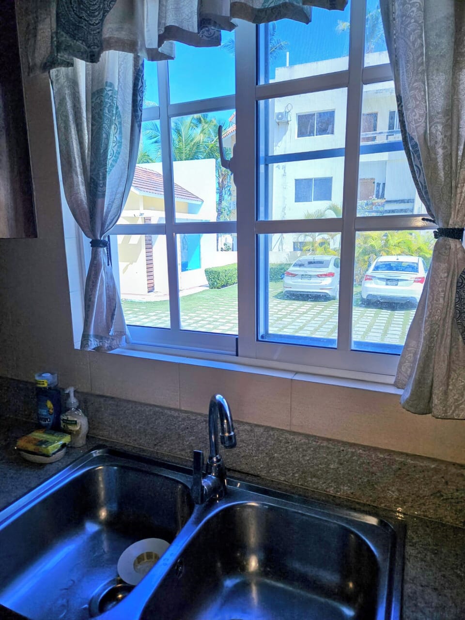 kitchen window view to parking lot and front gate guard station