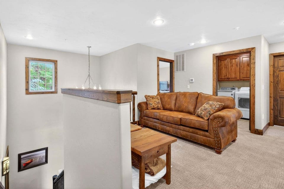Upstairs loft area with laundry room behind, access to two upper-level bedrooms from this area