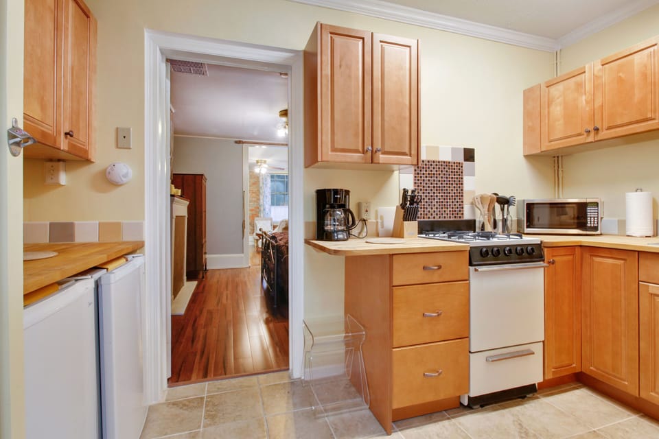 Quaint kitchen, butcher block counter space. 