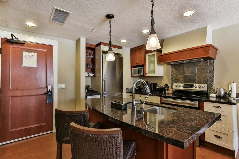 The gourmet, eat-in kitchen is fully stocked and features stainless steel appliances.