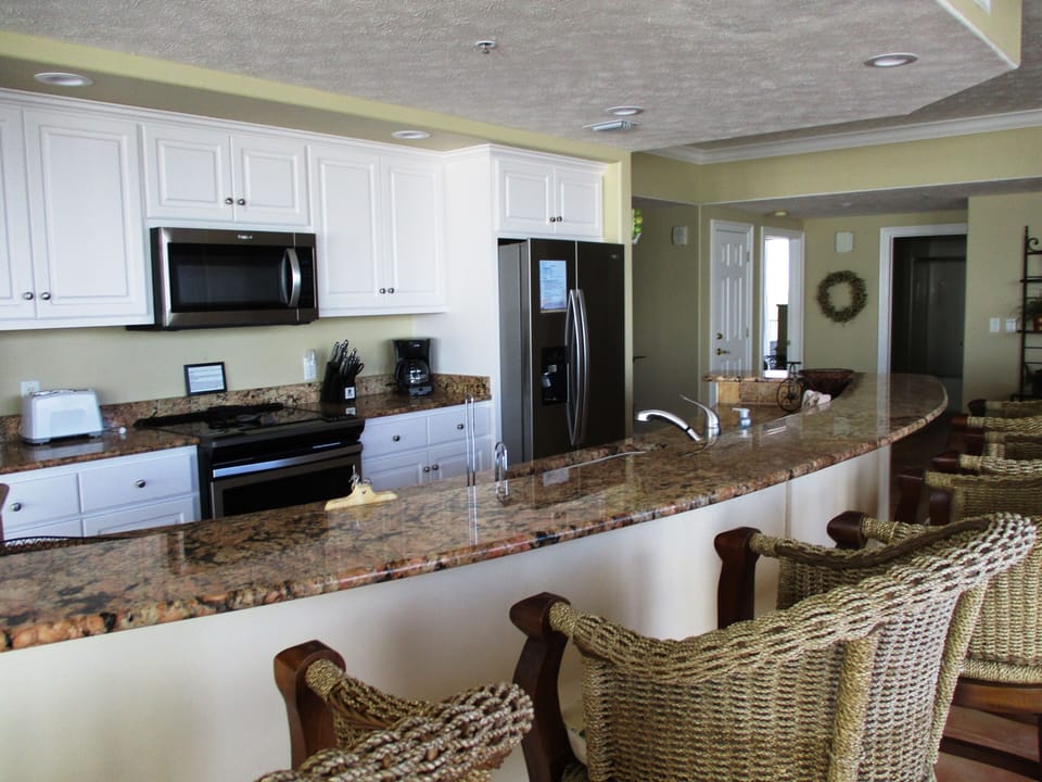Kitchen features granite counter tops and new stainless steel appliances