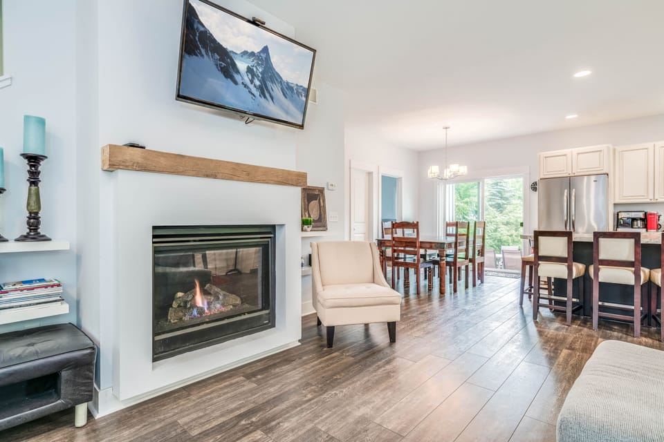 Great room w/ living room, family room w/ gas fireplace, kitchen/dining areas.