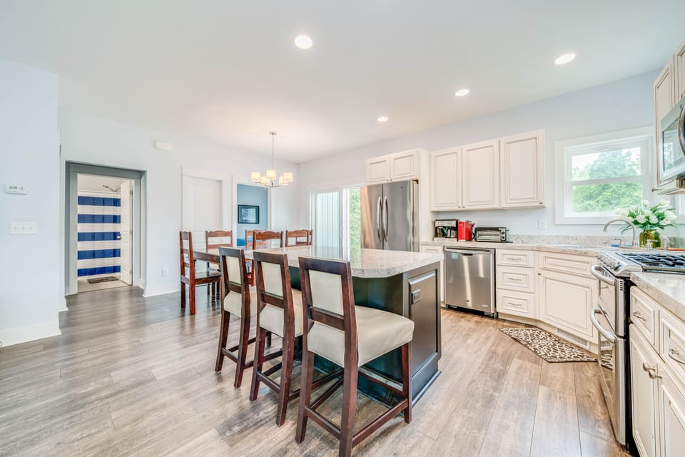 Kitchen w/ island, stainless steel appliances and dining areas