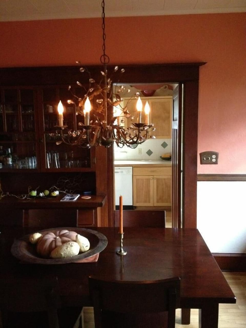 A period chandelier provides soft light for a romantic dining experience.