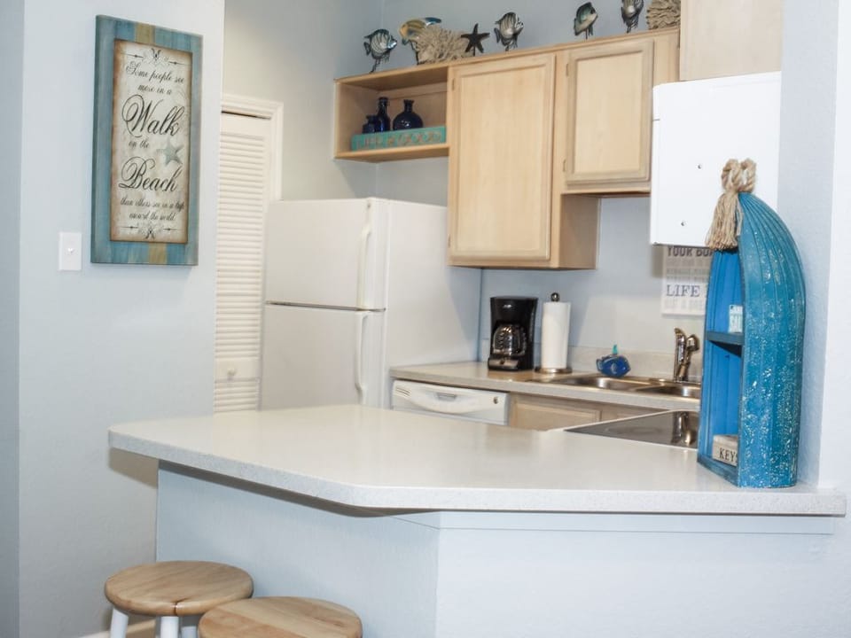 Door by refrigerator opens to a washer and dryer. 